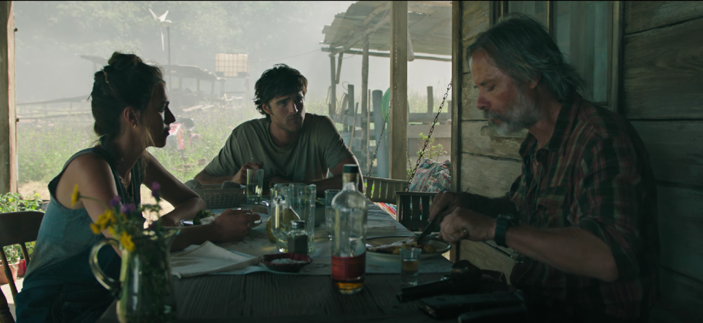 Jacob Elordi as Hig and Margaret Qualley looking at another person with worried expressions in The Dog Stars