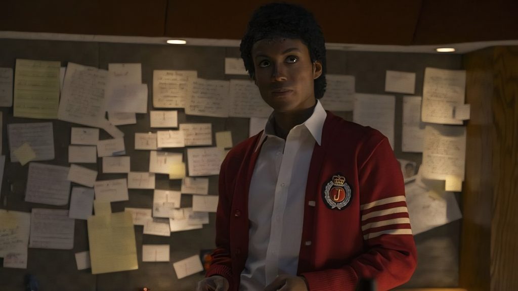 Jaafar Jackson as Michael Jackson wearing a red blazer 