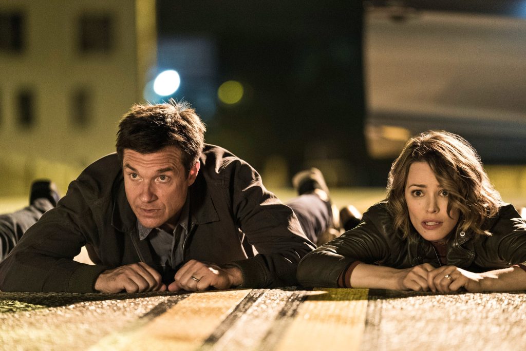 Jason Bateman and Rachel McAdams hide