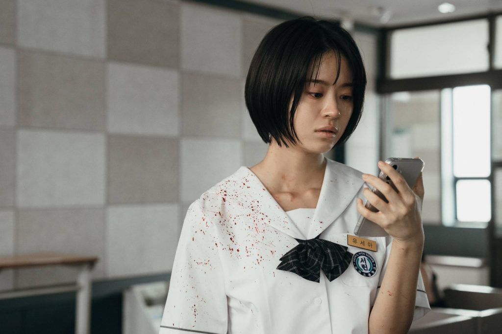 a girl looking at her phone in if wishes could kill