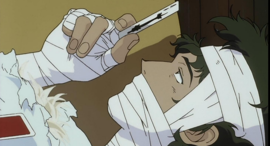 Injured spike looking at a card in cowboy bebop