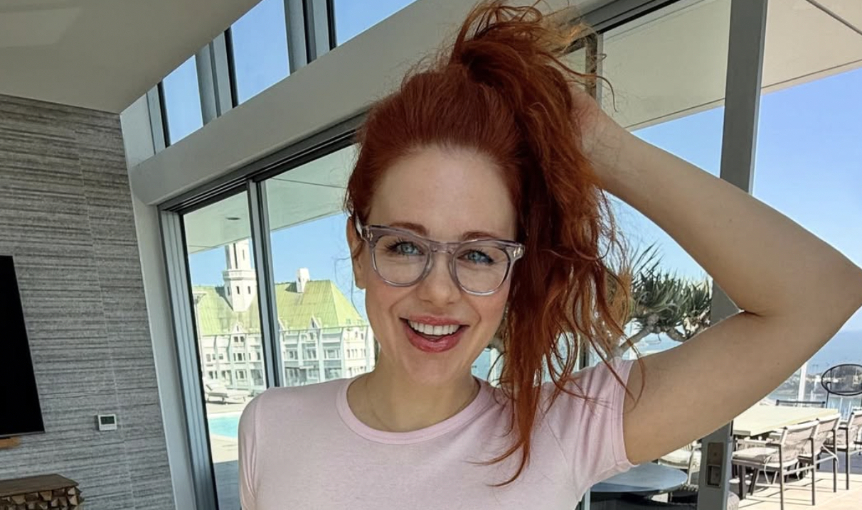 Maitland Ward holding her hair up 