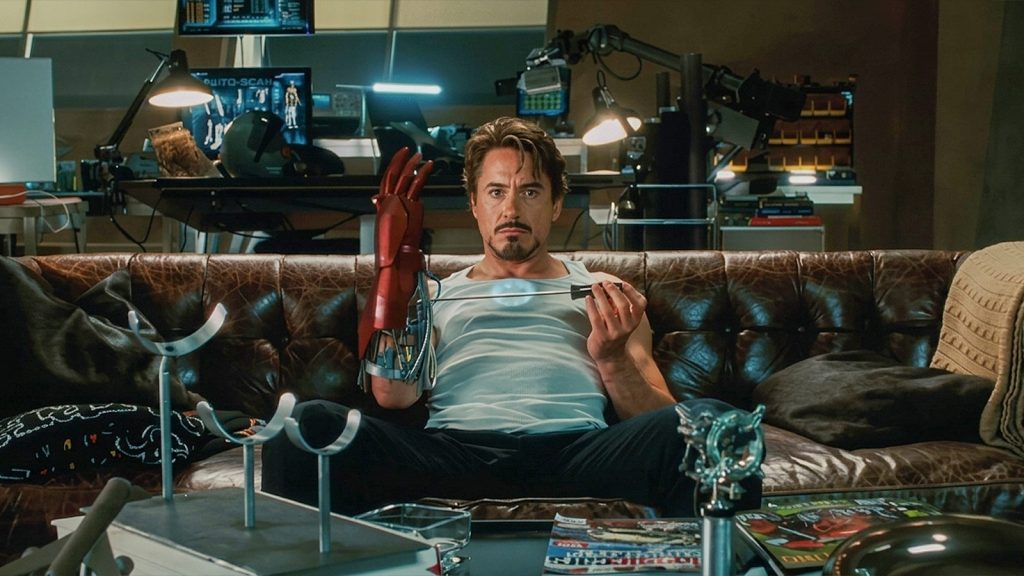 robert downey jr as tony stark in iron man fixing the forearm of his suit