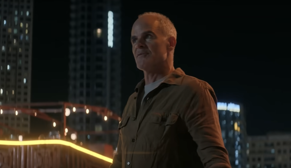 Michael Kelly in a brown shirt 