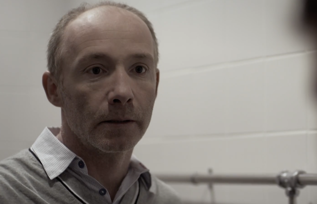 Diarmuid de Faoite in a gray attire 