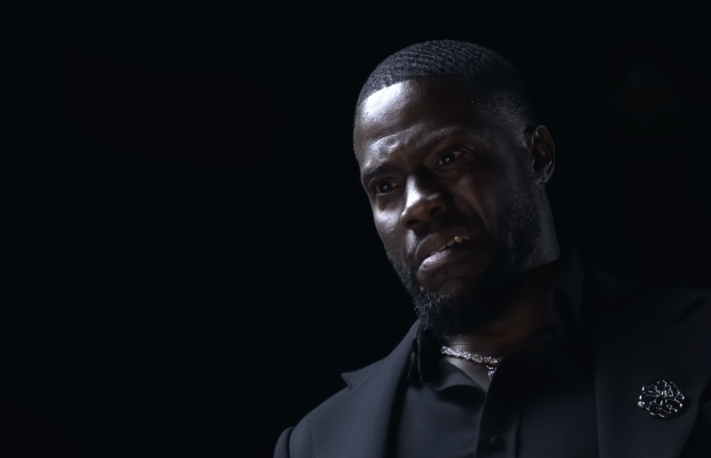 Kevin Hart wearing a black suit 