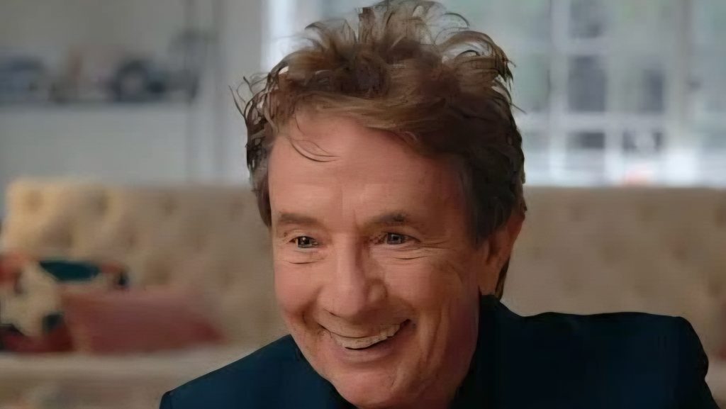 A man being interview and smiling on camera