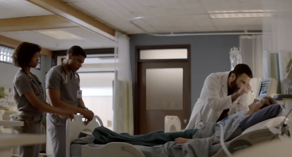 A doctor examining a patient in NBC's Brilliant Minds 