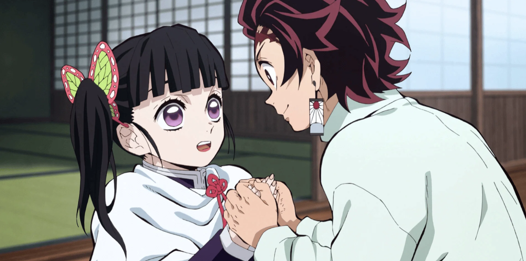 a still image of tanjiro holding kanao's hands and requesting her to teach him flower breathing in demon slayer