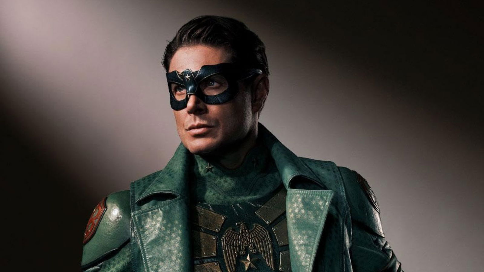 Jensen Ackles as Soldier Boy in a promotional portrait, wearing a dark star-emblazoned mask and ornate green military coat with eagle insignia in Vought Rising (2027)