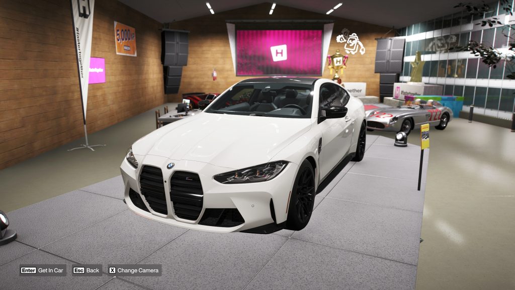 The BMW M4 Competition Coupé 'Welcome Pack' DLC car showcased in the Forza Horizon 6 showroom.
