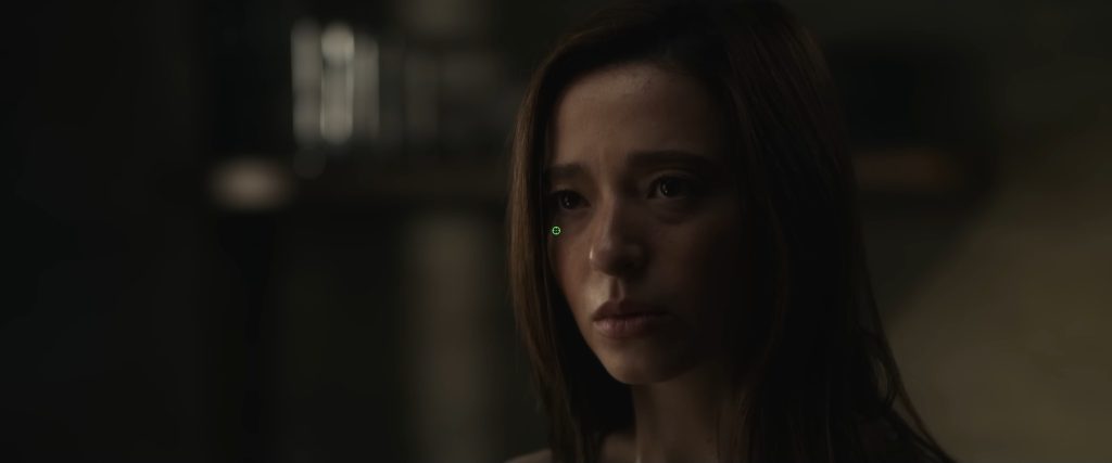 Mikey Madison as Frances Haugen in The Social Reckoning, looking distressed in a dimly lit scene