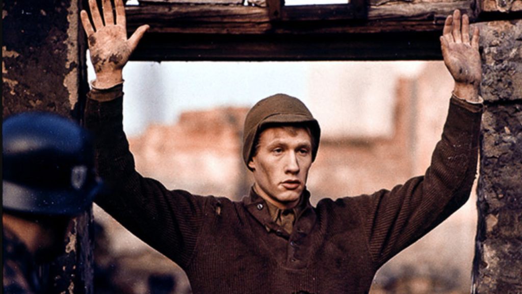 Michael Sacks as Billy pilgrim, with his hands up