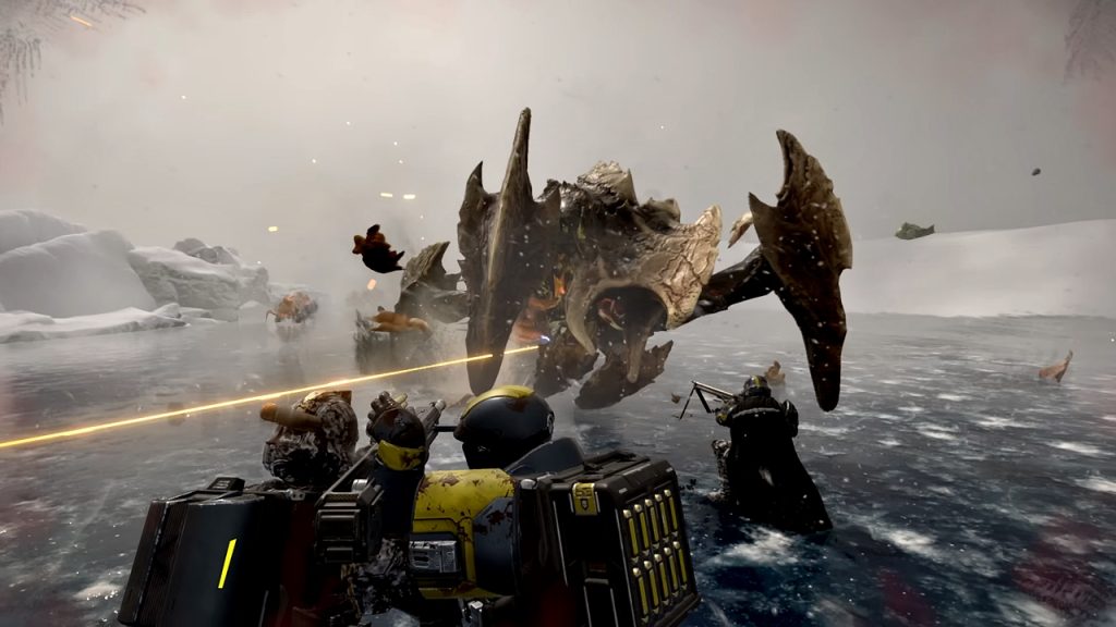 Helldivers 2 gameplay screenshot shows a squad of players working together to take down a Terminid Charger Behemoth enemy.