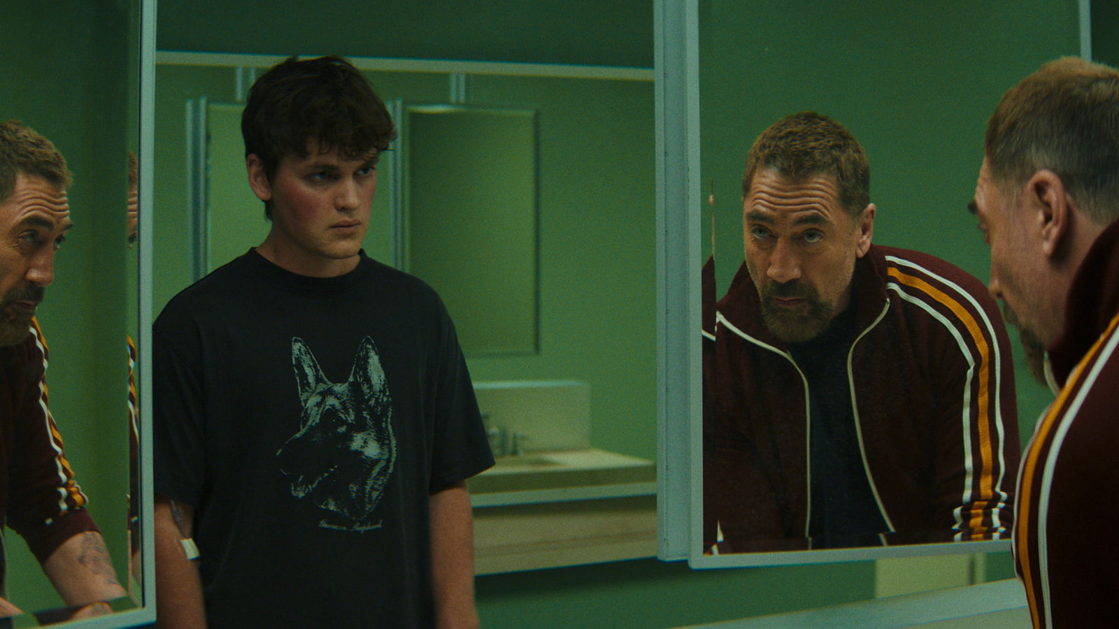 Max Cady speaks to Zack in a public restroom as the troubled teenager stands silently before a mirror 