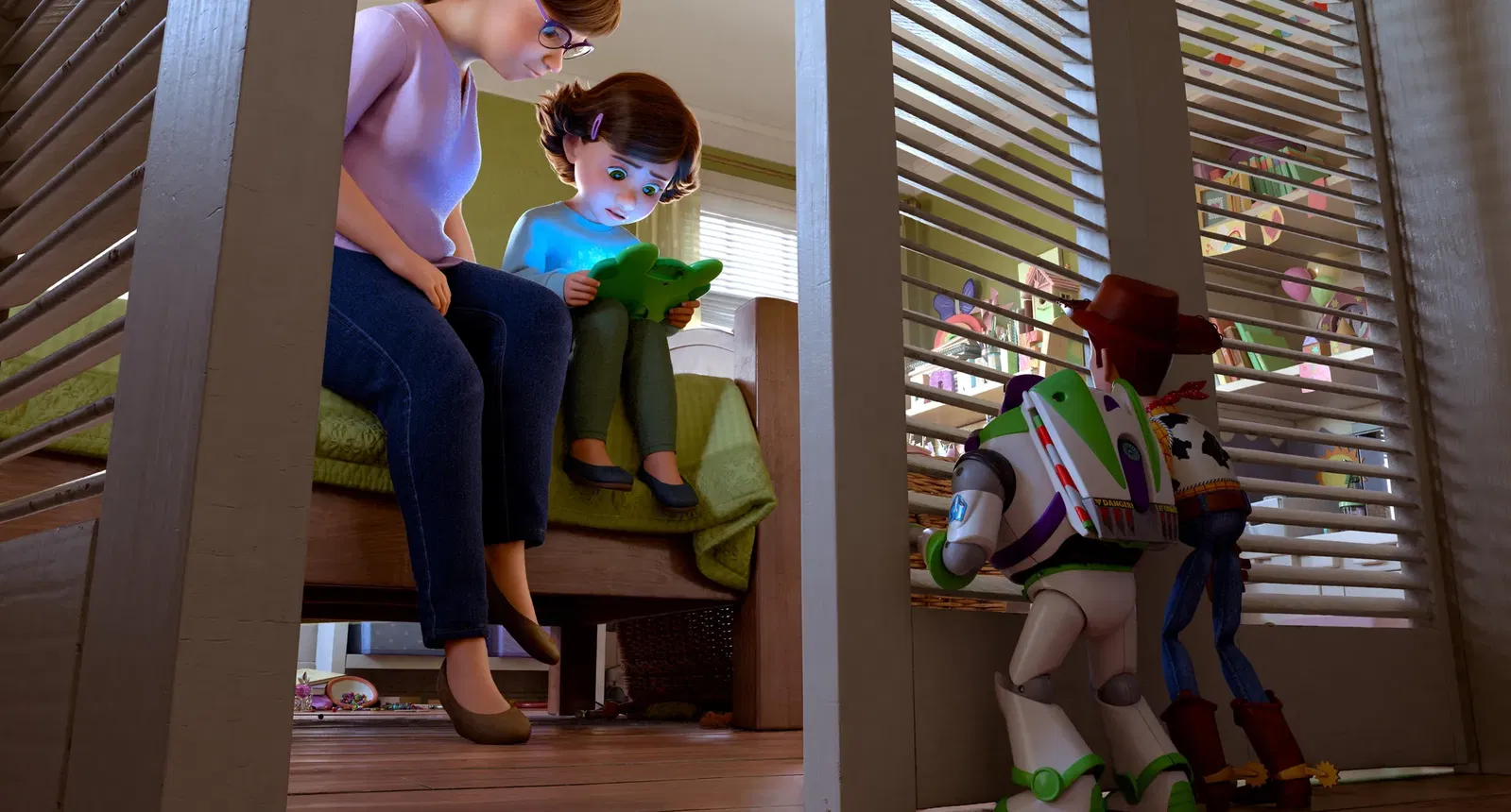 Bonnie sits beside her mother on a bed while looking at a frog-shaped tablet, as Woody and Buzz Lightyear secretly watch from outside the room in Toy Story 5.