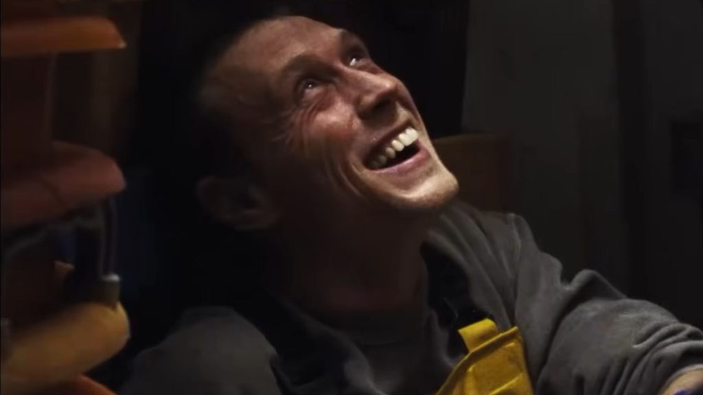 Nick smiles and looks upward inside the Rose of Nevada's cabin