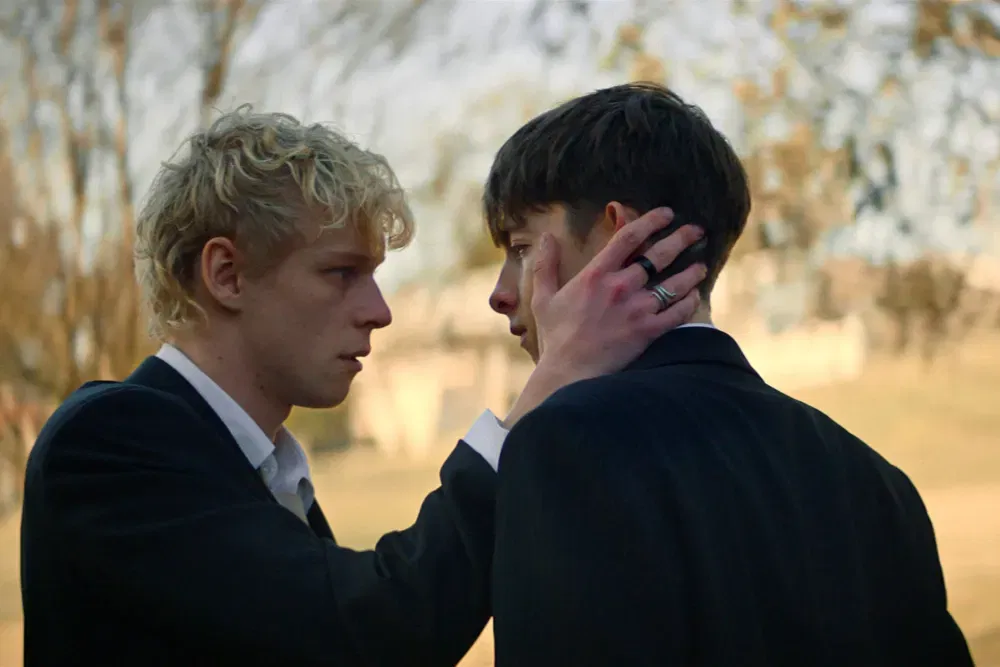 a still from leviticus featuring two boys looking at each other 