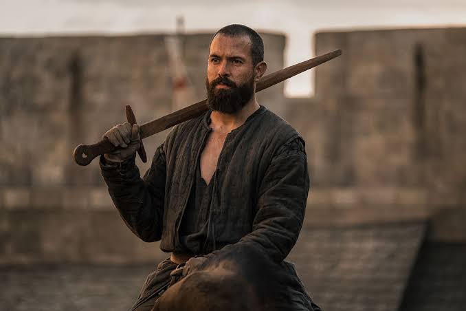 Tom Cullen with a sword
