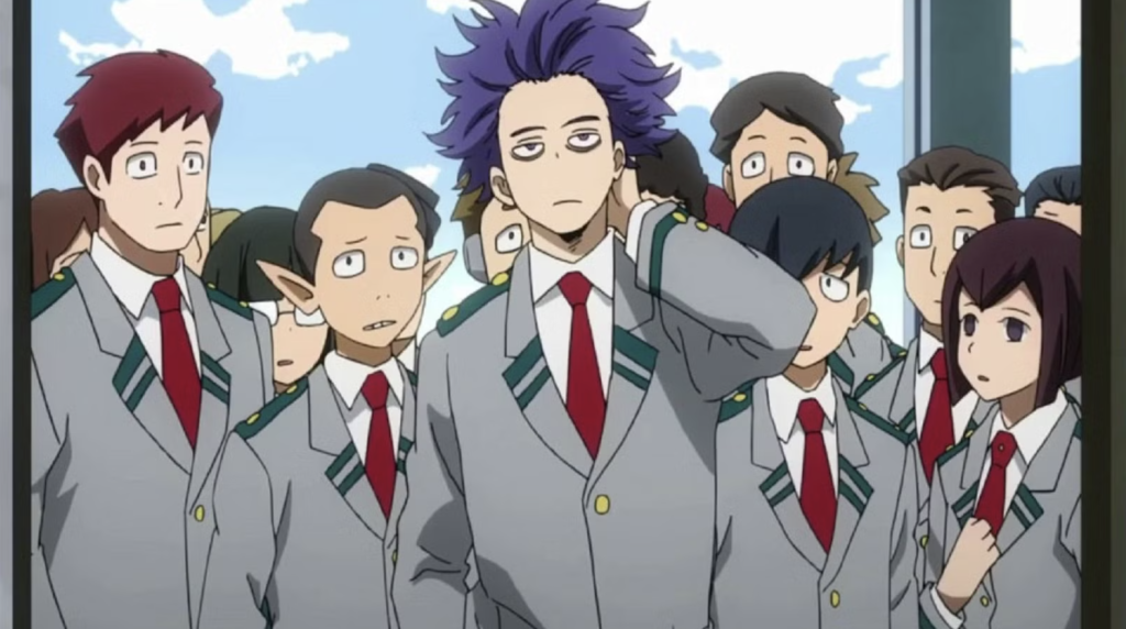 This image features Hitoshi Shinso from the anime series My Hero Academia. He is depicted here standing in a crowd of students wearing the standard gray U.A. High School uniform.