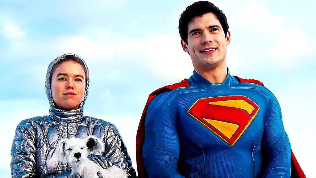 Supergirl stands beside Superman while holding Krypto shortly after arriving on Earth from Krypton.
