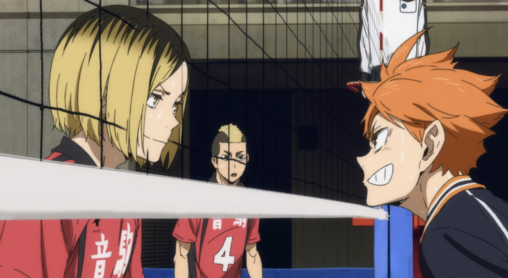 This scene is from the 2024 film Haikyu!! The Dumpster Battle, produced by Toho Animation and distributed by Crunchyroll. The image features characters Kenma Kozume and Shoyo Hinata during a pivotal volleyball match between Nekoma High and Karasuno High.