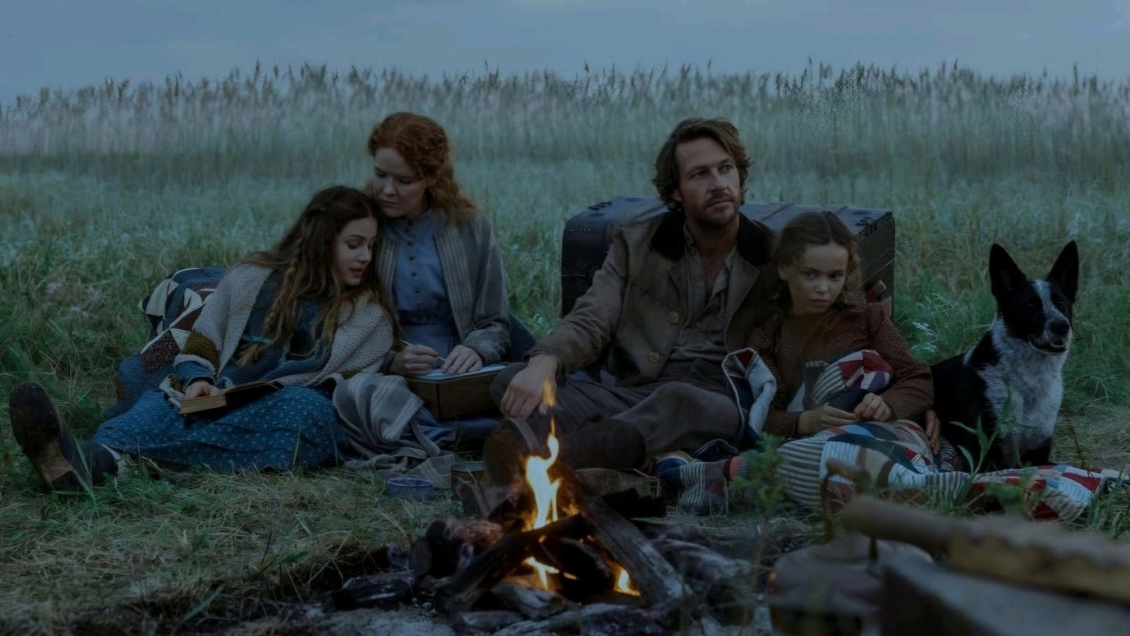 A family sits in a field dreaming of a little house on the prairie