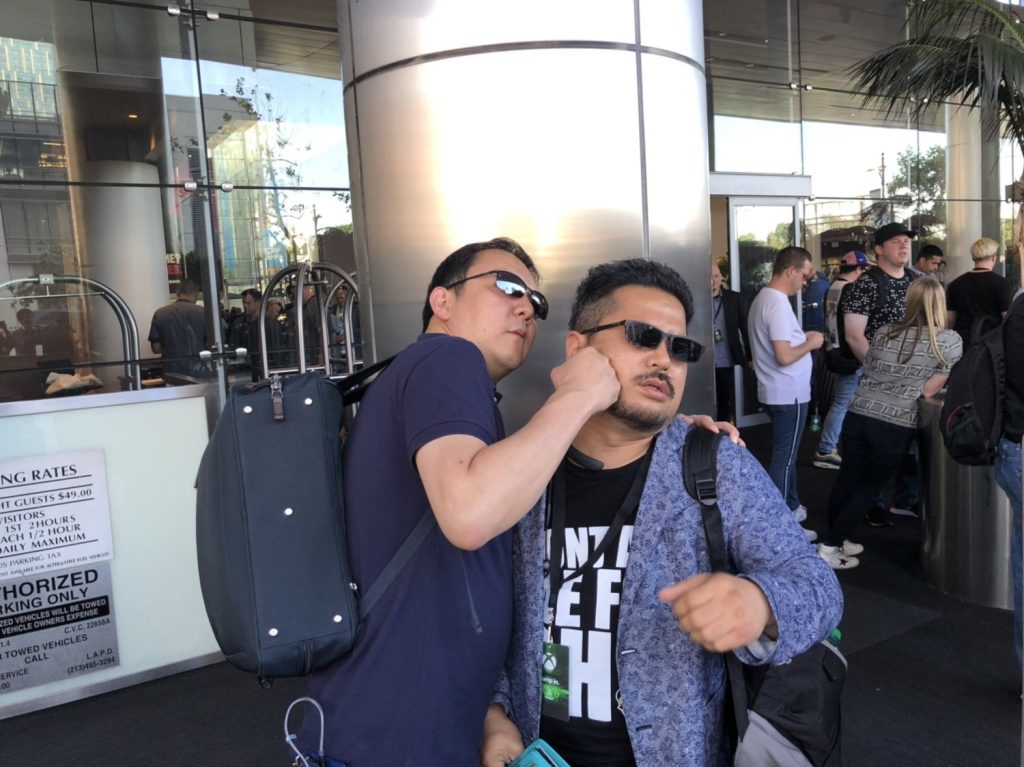 Hidetaka Miyazaki playfully punching Katsuhiro Harada.