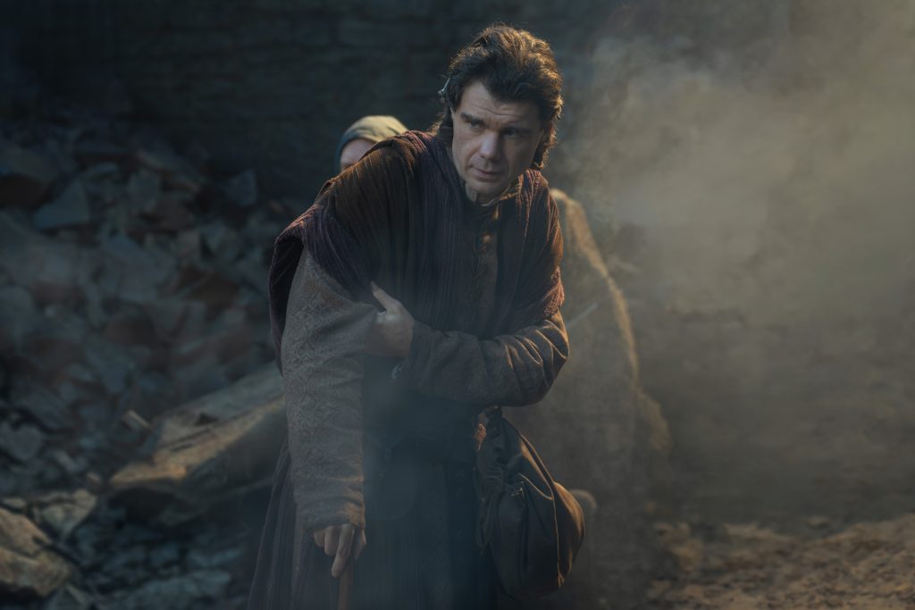 a man with a cane tries to shield his ally