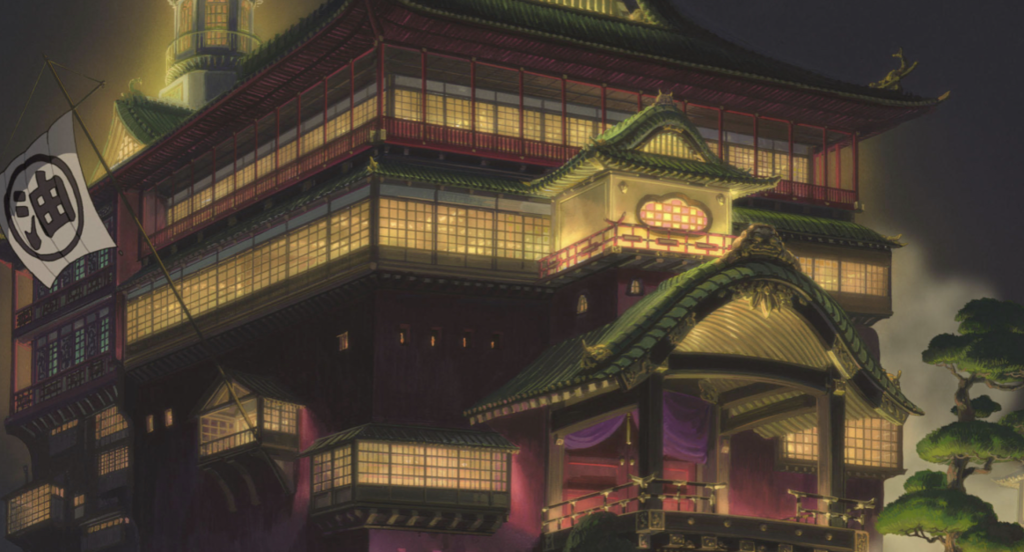 This image depicts the iconic Aburaya bathhouse from the 2001 Studio Ghibli film, Spirited Away. The building's design is heavily inspired by traditional Japanese architecture, featuring a distinct "karahafu" (curved gable) roofline. While a fictional setting, its design bears resemblance to real-world locations like the Sekizenkan ryokan in Japan.