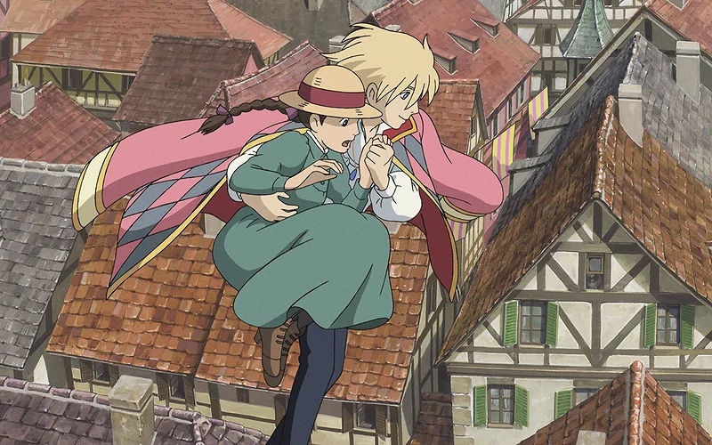 This is a scene from the 2004 Studio Ghibli film Howl's Moving Castle, directed by Hayao Miyazaki. The image features the characters Sophie and Howl walking in the air over the town of Market Chipping.