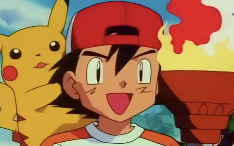 This scene is from the episode "All Fired Up!" in the Pokémon: Indigo League series. The image features Ash Ketchum acting as the torchbearer for the Pokémon League tournament.