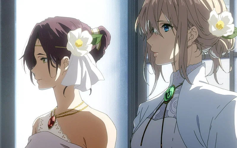 This scene is from the Kyoto Animation film Violet Evergarden: Eternity and the Auto Memory Doll. The characters are Isabella York (left) and Violet Evergarden (right), both wearing white garments adorned with White Camellia flowers, which symbolize adoration and perfection.