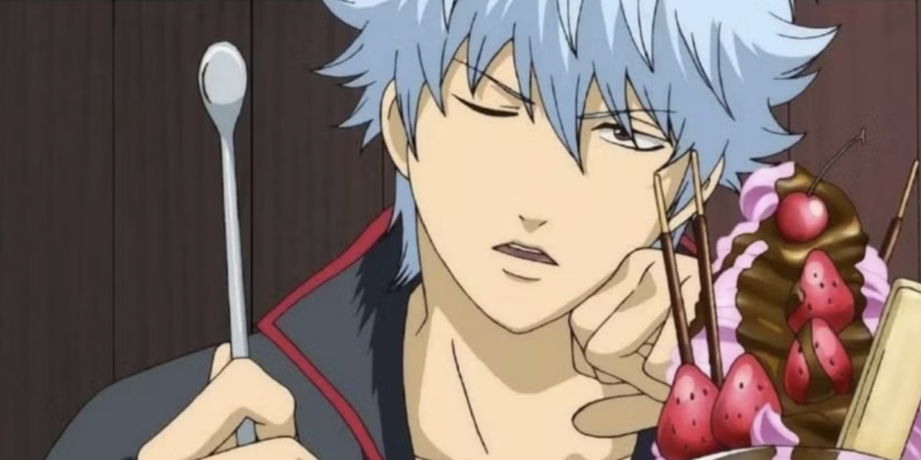 Gintoki Sakata is enjoying a large parfait. He is the main character of the Gintama series.
