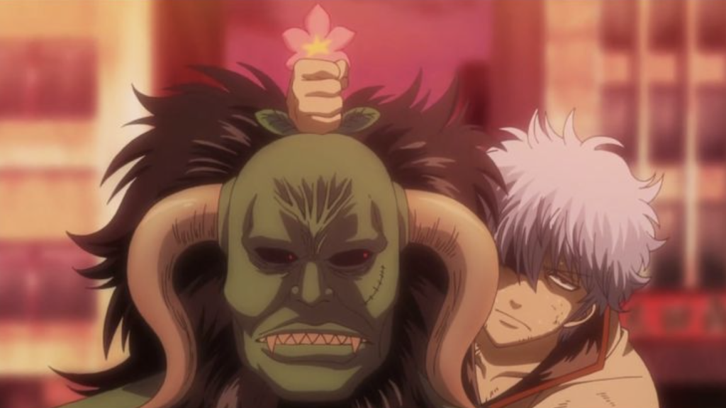 Gintoki Sakata is seen hiding behind the formidable, demon-like character Hedoro, who is unexpectedly being controlled by a flower. 