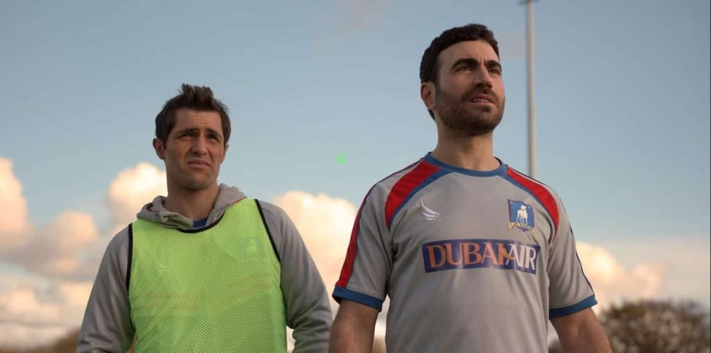 Roy Kent and Jamie Tartt stand side by side on the AFC Richmond training ground during a practice session in Ted Lasso.
