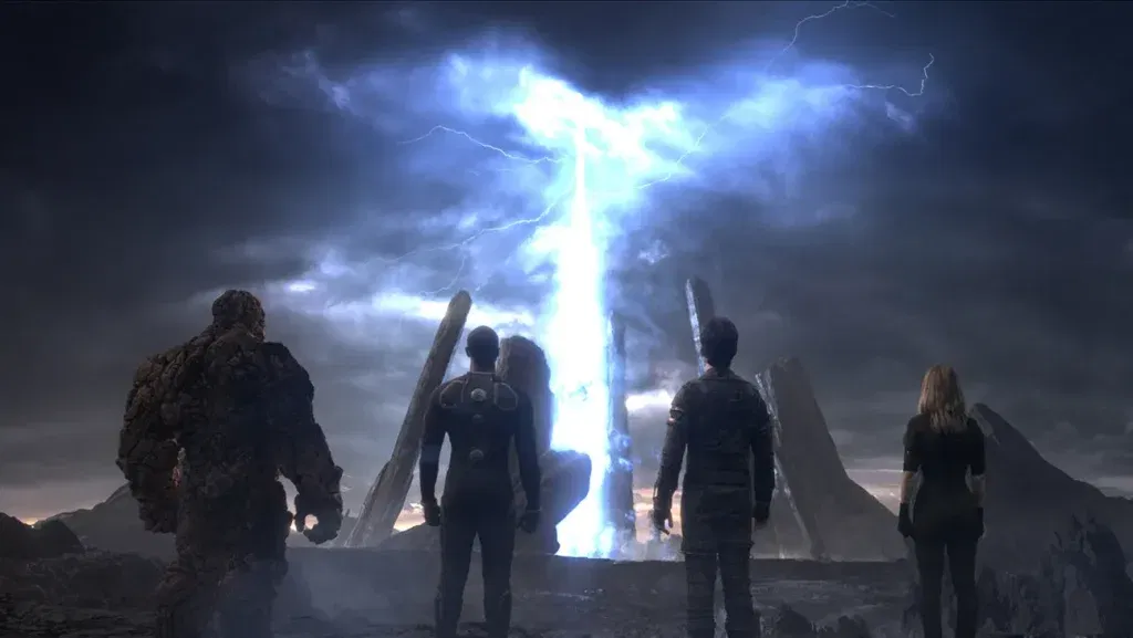 Four superheroes stand before a towering column of blue energy under a stormy sky in a scene from Fantastic Four (2015).