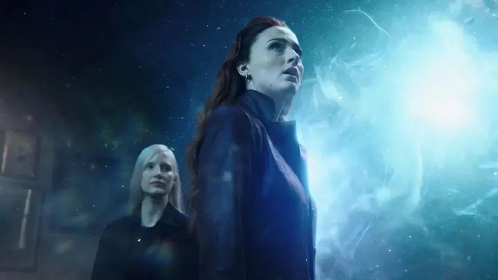 Jean Grey stands beside Vuk as a powerful cosmic energy engulfs the sky in a scene from Dark Phoenix.
