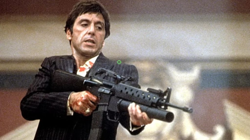 Al Pacino as Tony Montana holding an assault rifle during the climactic shootout in Scarface.