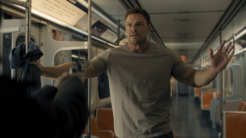 A man looks concerned in a subway car