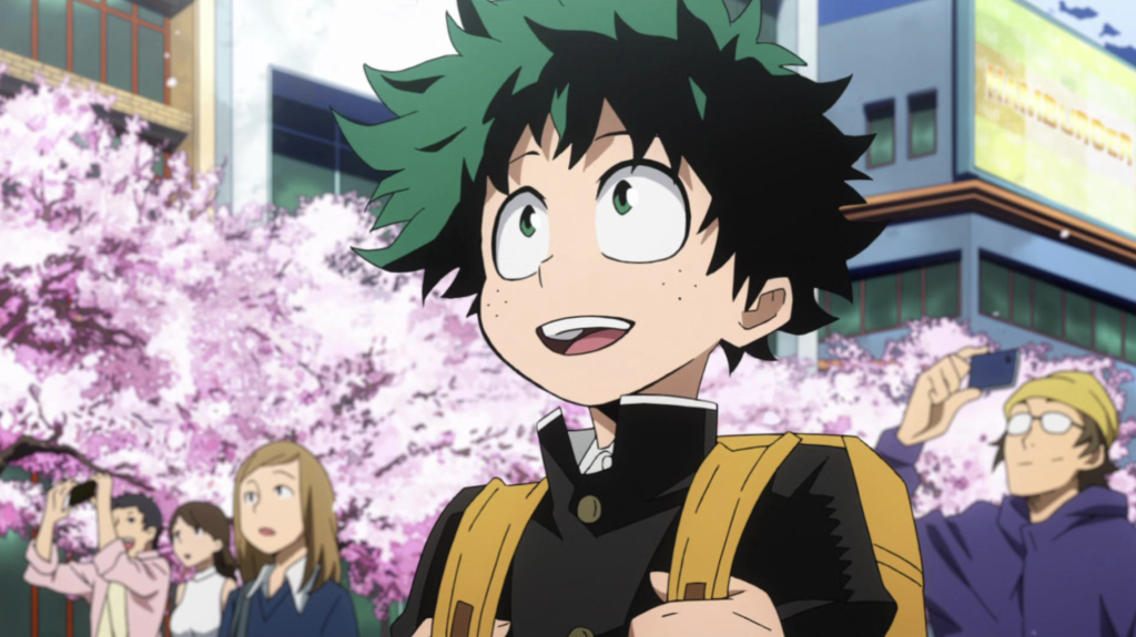 Izuku Midoriya từ bộ anime My Hero Academia được thể hiện ở đây như một cậu học sinh trung học trẻ tuổi, không có năng lực đặc biệt, đang ngước nhìn với vẻ ngưỡng mộ và kinh ngạc.