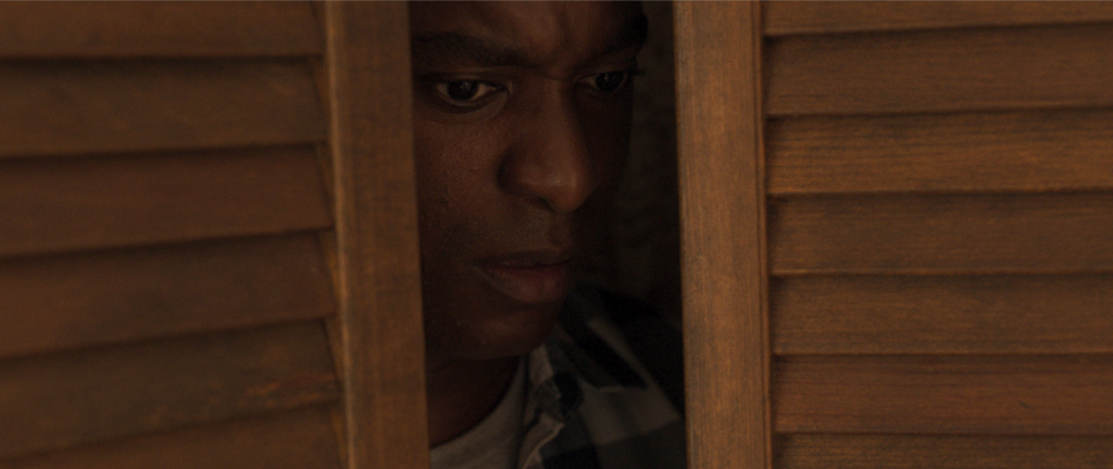 A person peeking through a doorway in Parasomnia