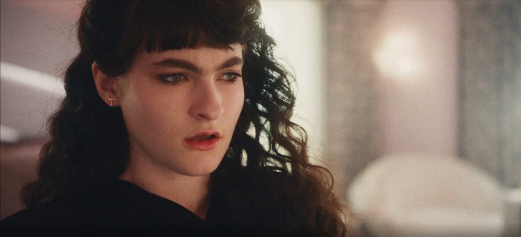 The Shards Episode 6 And 7 Ending Explained: Why Did Rhonda Accuse Susan Of Kidnapping Her? 2 Rhonda, played with dark blunt bangs and heavy smoky eye makeup, gazes off to the side with a distant, unreadable expression in The Shards.
