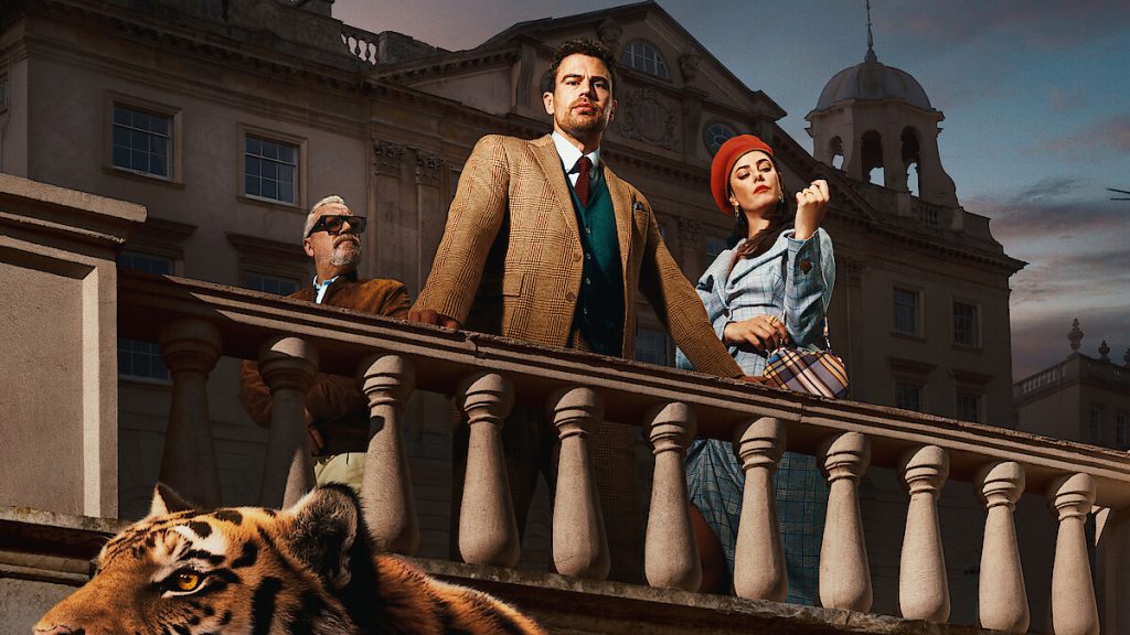 Theo James and Kaya Scodelario stand on a balcony with a tiger in The Gentlemen Season 2 key art