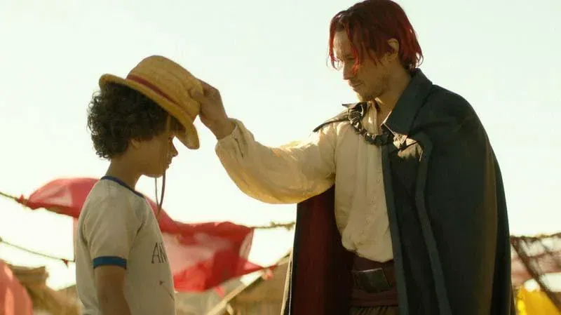 Peter Gadiot as Shanks and Colton Osorio as a young Monkey D. Luffy in the live-action Netflix series One Piece.