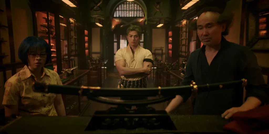 Roronoa Zoro played by Mackenyu in a sword shop with the weapon seller Ipponmatsu played by James Hiroyuki Liao in the live-action series One Piece.