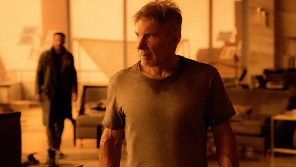 Harrison Ford as Deckard walks through Sapper Morton's home as K looks on in Blade Runner 2049