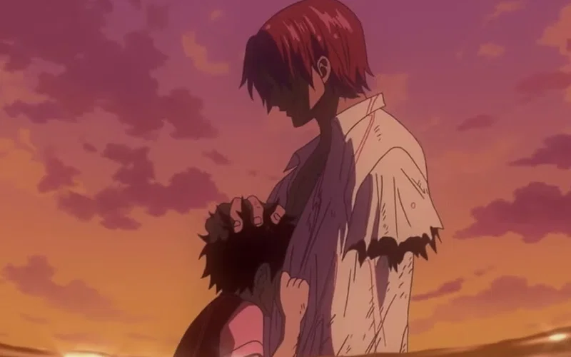 This image shows Red-Haired Shanks comforting a young Monkey D. Luffy in an emotional scene from the anime series One Piece.