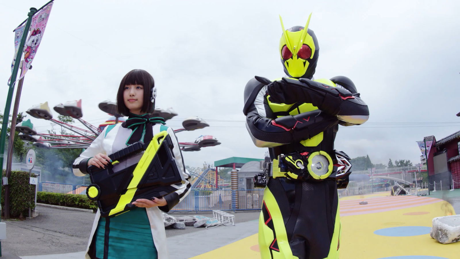 Kamen Rider Zero-One standing with a woman in a still from the TV show.