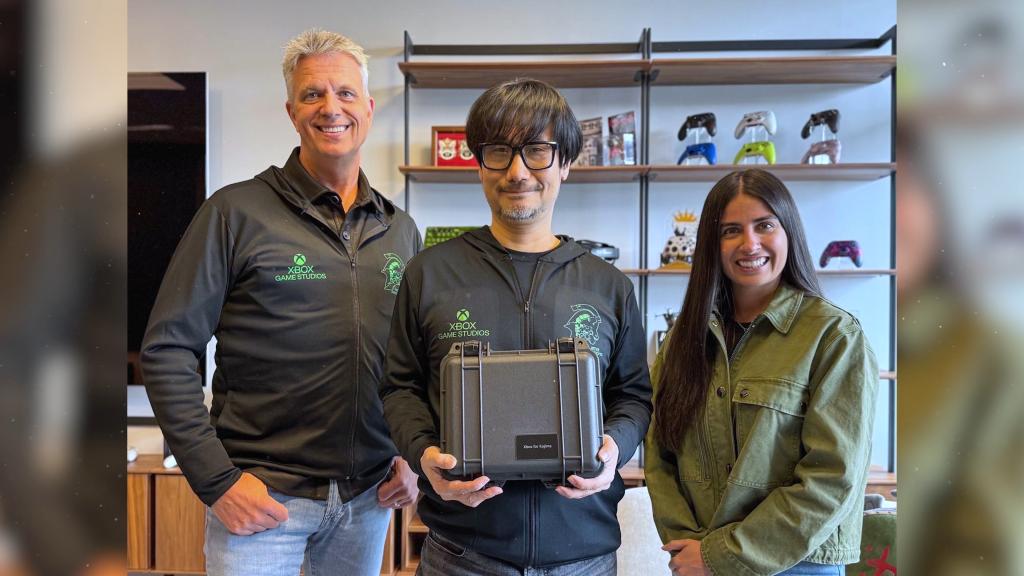 A photo featuring Hideo Kojima posing alongside Xbox executives Matt Booty and Asha Sharma.